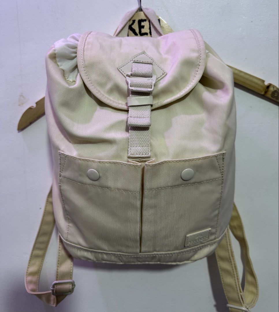 Doughnut beige mini backpack (Category: Backpacks) located in Manila. Submitted by esparciake75752 (Listing ID 1465305226, Image 3). Description: - Brand: Doughnut - Color: Beige - Closure: Drawstring under main flap with front snap pockets - Straps: Adjustable shoulder straps and convenient top carry handle - Condition: Clean fabric exterior with signature brand patch - Usage: Compact size, ideal for daily commutes or quick trips.
