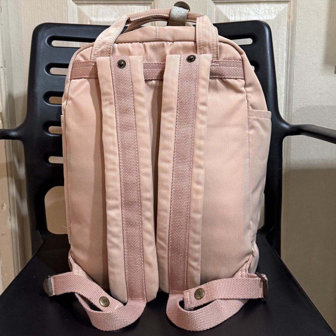 Doughnut Macaroon Backpack Pink (Category: Backpacks) located in Makati City. Submitted by julyco. (Listing ID 1465357435, Image 3). Description: - Brand/Model: Doughnut Macaroon Backpack - Color: Dusty Pink with Cream Leather Accents - Material: Durable Nylon Fabric with Metal Hardware - Storage: Main dual-zipper closure, front zipped compartment, and side pockets - Features: Top carrying handles with snap button tab and adjustable back straps -
