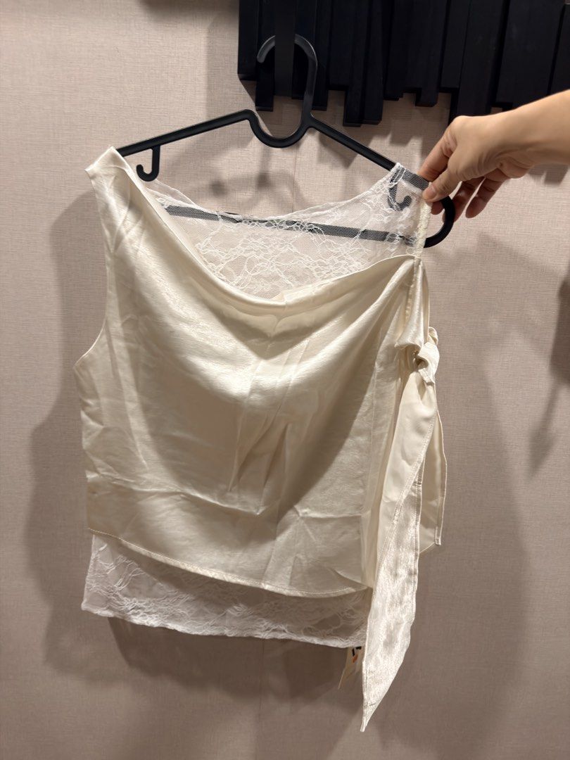 Drape Silky Lace top, FS (Category: Others Tops) located in Pasig City. Submitted by theclosetcasemanila (Listing ID 1465339501, Image 1). Description: Brand new Silky material with lace accent inner Drape neck Asymmetrical shoulder with tie Bust fits upto 36”.