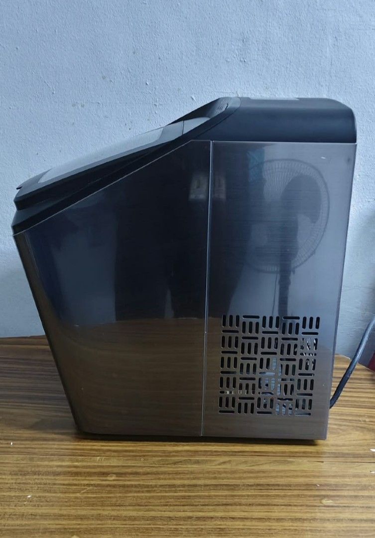 Dreamiracle IM2200-UL Countertop Ice Maker (Category: Refrigerators and Freezers) located in Taguig. Submitted by thrifthub.ph (Listing ID 1465213436, Image 2). Description: Dreamiracle IM2200-UL countertop ice maker. Stainless steel finish with black accents and a clear viewing window on top. Includes removable white plastic ice basket inside. Built-in cooling fan and power cord at the back. Manufactured May 2021. Operates on 120V AC. Powers on 