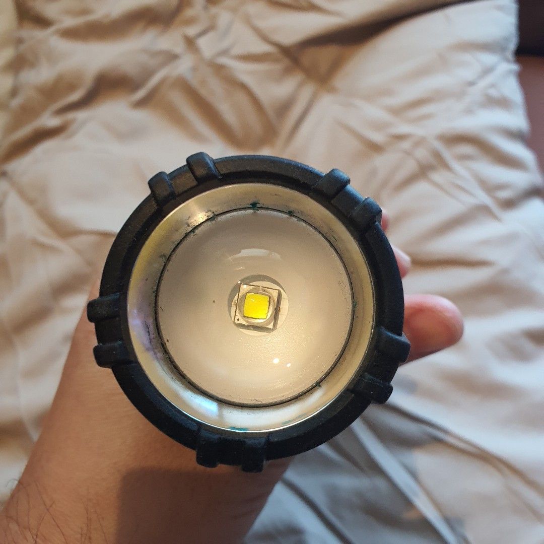 Duracell 1000 Lumens LED Flashlight (Category: Lighting) located in Quezon City. Submitted by wenaileditconstruction (Listing ID 1465177038, Image 3). Description: - Brand: Duracell - Brightness: 1000 lumens - Color: Black - Build: Heavy duty with textured grip handle for a secure hold - Focus: Adjustable zoom focus head with a twist mechanism - Reflector: Large LED bulb inside a smooth reflector cone - Power Source: Battery-operated (compartment