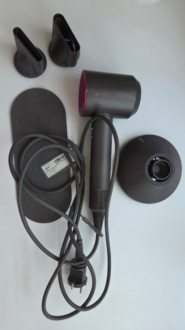 Dyson Supersonic Hair Dryer with Complete Attachments (Category: Hair) located in Muntinlupa City. Submitted by declutter.project (Listing ID 1465178488, Image 2). Description: Authentic Dyson Supersonic hair dryer in grey and pink. Includes complete styling attachments and non-slip mat. Issues: Scuffs and chipping on the body (as shown in photos), but functionality not affected..