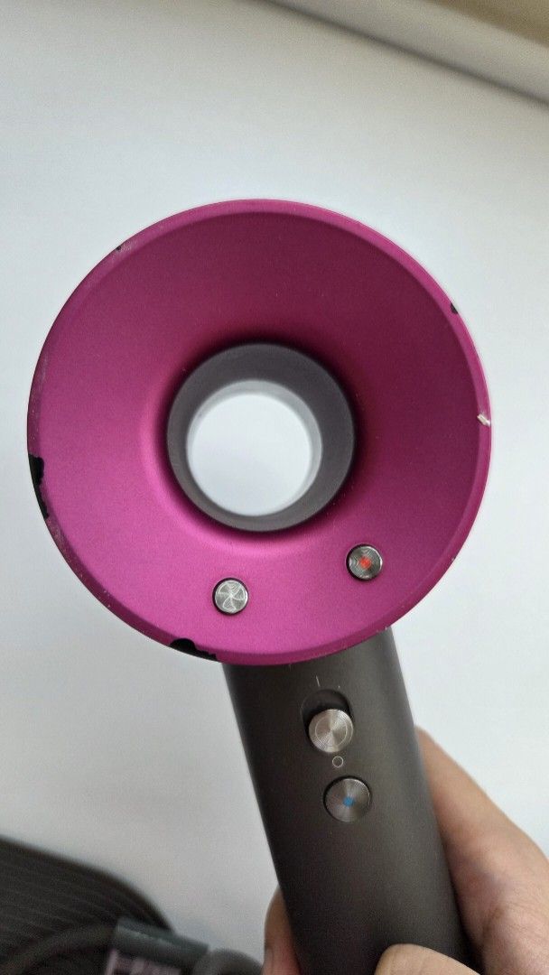 Dyson Supersonic Hair Dryer with Complete Attachments (Category: Hair) located in Muntinlupa City. Submitted by declutter.project (Listing ID 1465178488, Image 3). Description: Authentic Dyson Supersonic hair dryer in grey and pink. Includes complete styling attachments and non-slip mat. Issues: Scuffs and chipping on the body (as shown in photos), but functionality not affected..
