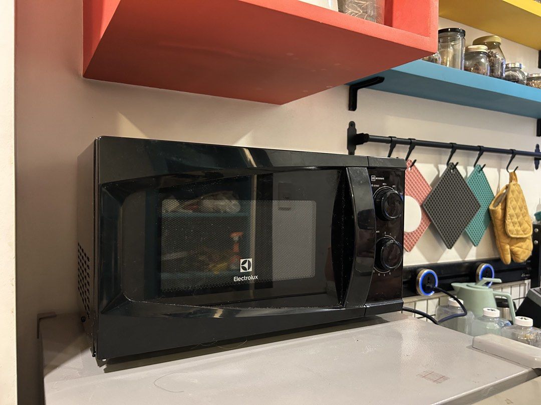 Electrolux Black Microwave Oven with Dual Rotary Dials (Category: Ovens & Toasters) located in Quezon City. Submitted by ccr26 (Listing ID 1465305579, Image 1). Description: Very seldom used in the office - Brand/Model: Electrolux Microwave - Color: Solid black finish - Type: Standard countertop size - Controls: Dual mechanical rotary dials for power and timer - Condition: Tested and working properly (minor dust on outer casing from kitchen place