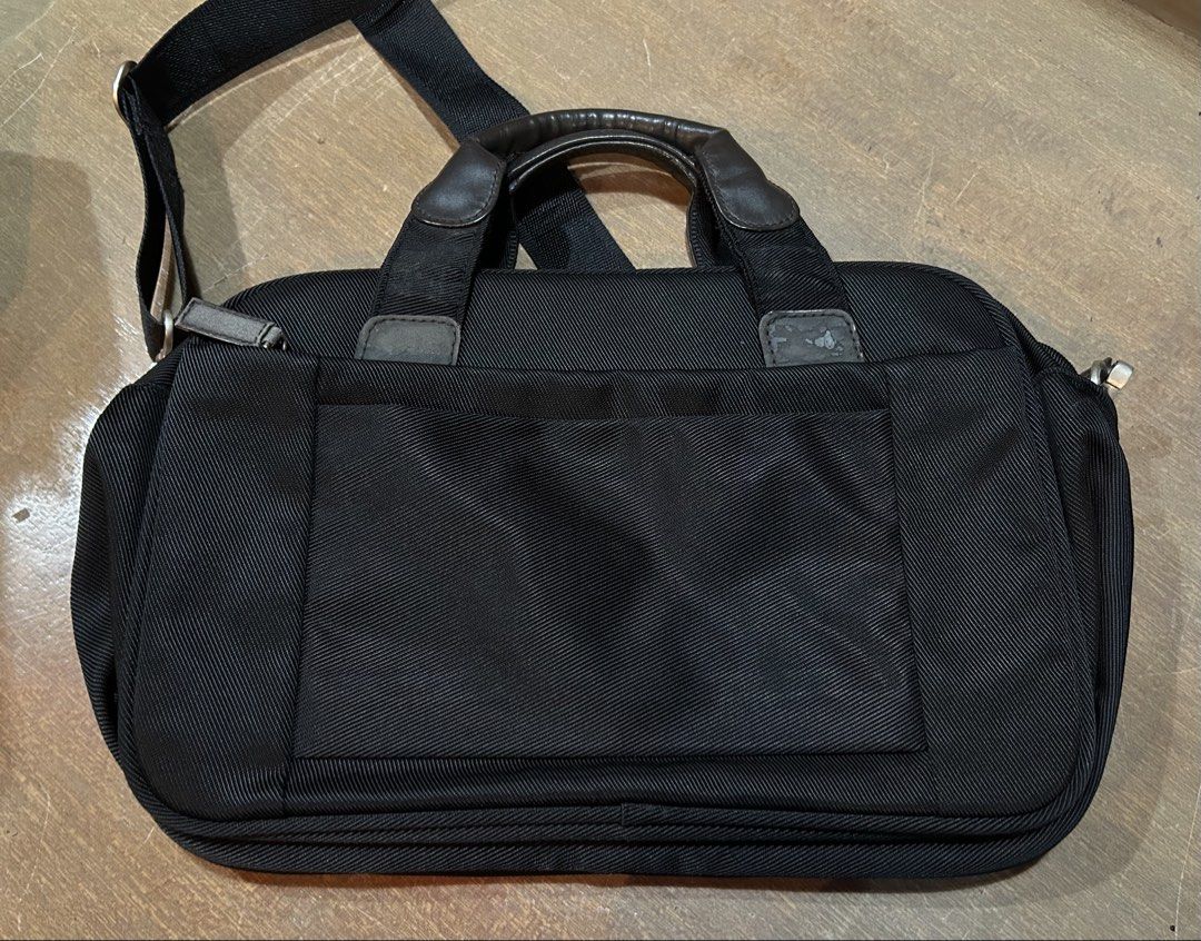 ELLE Black Nylon Shoulder Bag Briefcase (Category: Luxury Bags & Wallets) located in Makati City. Submitted by riad_88 (Listing ID 1465317717, Image 2). Description: - Brand: ELLE - Material: Durable black nylon with grey suede corner patches - Hardware: Silver brand plaque and button studs - Straps: Sturdy handles and adjustable shoulder strap - Compartments: Secure zip closure, patterned lining, multiple inner pockets (zippered and mesh), plus 