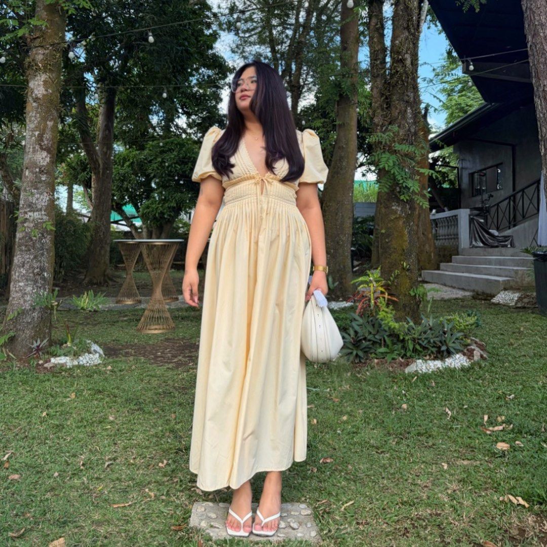 Enchnt Summer Solid Color Deep V-Neck Dress (Category: Dresses) located in Valenzuela. Submitted by arcake (Listing ID 1465378376, Image 3). Description: - Brand: Enchnt - Style: Yellow midi dress with flared skirt - Details: Deep V-neckline with bust tie, chic puff sleeves - Fit: Comfortable smocked elastic waist - Fabric: Light and airy, ideal for warm weather - Condition: Worn once, freshly washed, and ready to ship.
