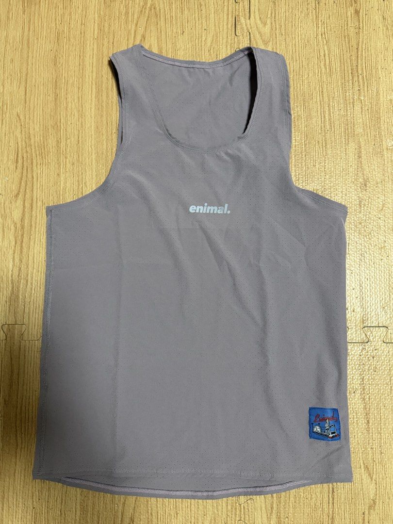 enimal perforated gym workout tank top mink (Category: Activewear) located in Angeles City. Submitted by reginageorge22 (Listing ID 1465288580, Image 1). Description: Enimal athletic tank top in a dusty purple shade (mink - soldout color) Used once. Lightweight perforated fabric keeps you cool during workouts. Small 'enimal.' logo printed on the chest, plus a woven brand patch near the lower hem. Round neckline and sleeveless cut. Back features a