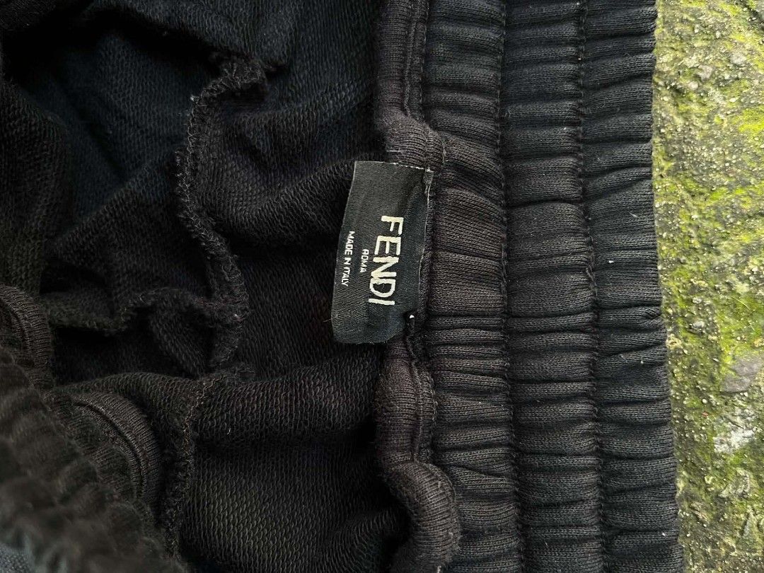 Fendi Black Jogger Pants with FF Side Tape (Category: Joggers) located in Manila. Submitted by sls.wear (Listing ID 1465206738, Image 2). Description: Fendi sweatpants in black. Elastic waistband with drawstring closure. Features FF logo tape down both side legs. Zippered pockets near the waist. Made in Italy, size 50. 100% cotton material. Interior brand tags and care label attached..