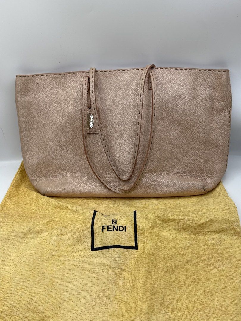 Fendi totebag (Category: Tote Bags) located in Caloocan City. Submitted by rossvault2 (Listing ID 1465231411, Image 1). Description: - Authentic Fendi Selleria tote bag in textured pink leather - Double shoulder straps with elegant contrast stitching - Hanging leather tag featuring the iconic metal Fendi Selleria plaque - Spacious interior with a zip pocket, authentic hologram tag, and serial number strip - Includes original matching yellow Fendi