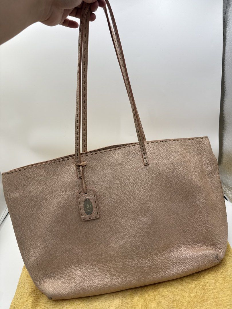 Fendi totebag (Category: Tote Bags) located in Caloocan City. Submitted by rossvault2 (Listing ID 1465231411, Image 2). Description: - Authentic Fendi Selleria tote bag in textured pink leather - Double shoulder straps with elegant contrast stitching - Hanging leather tag featuring the iconic metal Fendi Selleria plaque - Spacious interior with a zip pocket, authentic hologram tag, and serial number strip - Includes original matching yellow Fendi