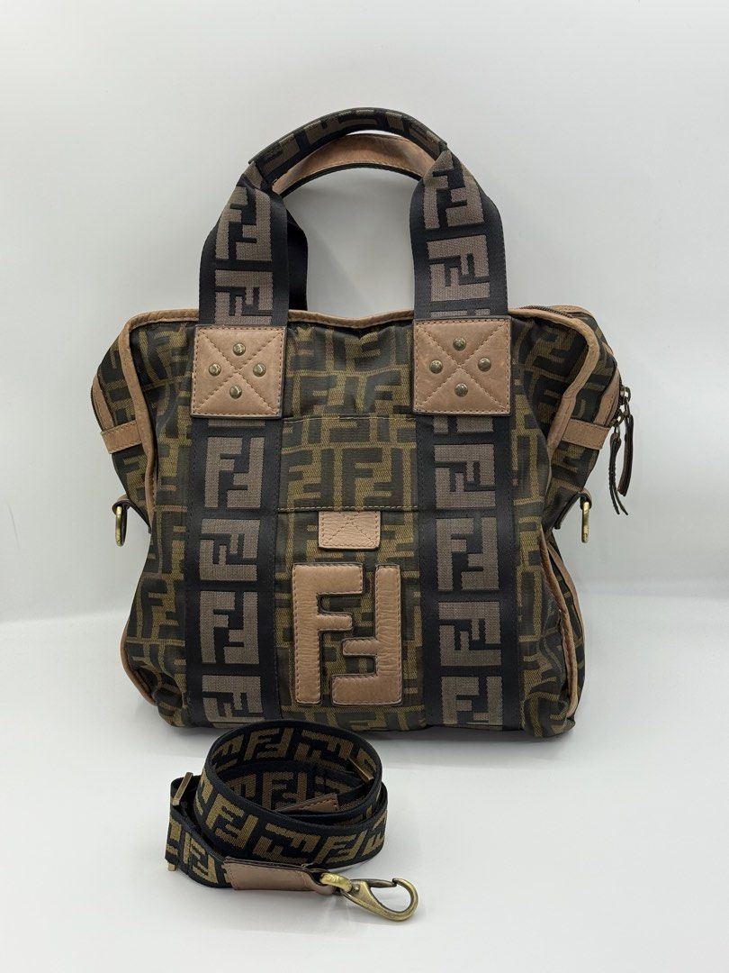 Fendi vintage (Category: Cross-body Bags) located in Caloocan City. Submitted by rossvault2 (Listing ID 1465236530, Image 3). Description: - vintage Fendi tote bag in classic brown Zucca canvas - Dual top handles plus an adjustable, detachable shoulder strap for versatile wear - Features stylish leather patches with metal studs and a prominent Fendi logo patch - Secure top zipper closure to keep your essentials safe - Includes original Fendi dust
