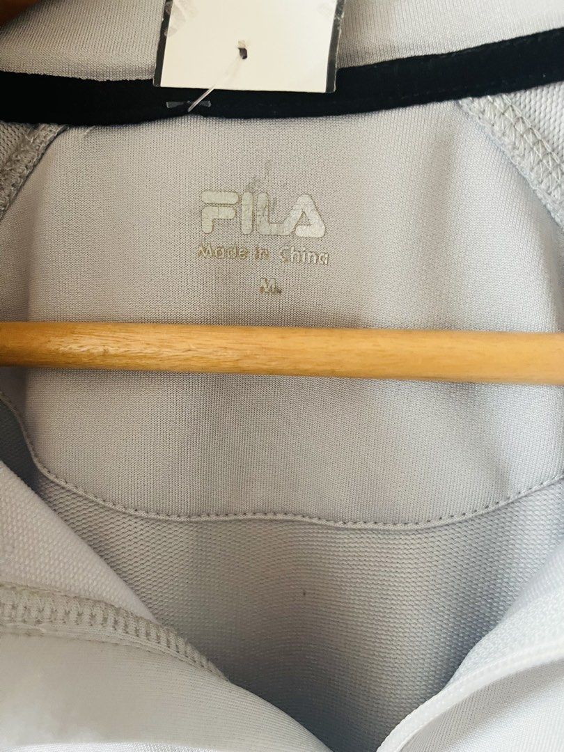 FILA 1/4 zip pullover (Category: Activewear) located in Quezon City. Submitted by wacpon_061972 (Listing ID 1465206684, Image 2). Description: This is a light gray and black FILA 1/4 zip active pullover featuring a stand collar and a zippered chest pocket..