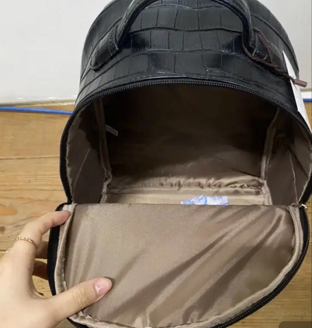 Finn Esker Black Crocodile Pattern Mini Backpack (Category: Backpacks) located in Manila. Submitted by lynnalec25 (Listing ID 1465362574, Image 2). Description: - Brand: Finn Esker - Condition: Brand new with original tag attached - Material/Design: Black backpack with a glossy crocodile embossed pattern - Hardware: Elegant gold-tone zippers, including a convenient front pocket - Comfort & Carry: Features a sturdy top handle and adjustable should