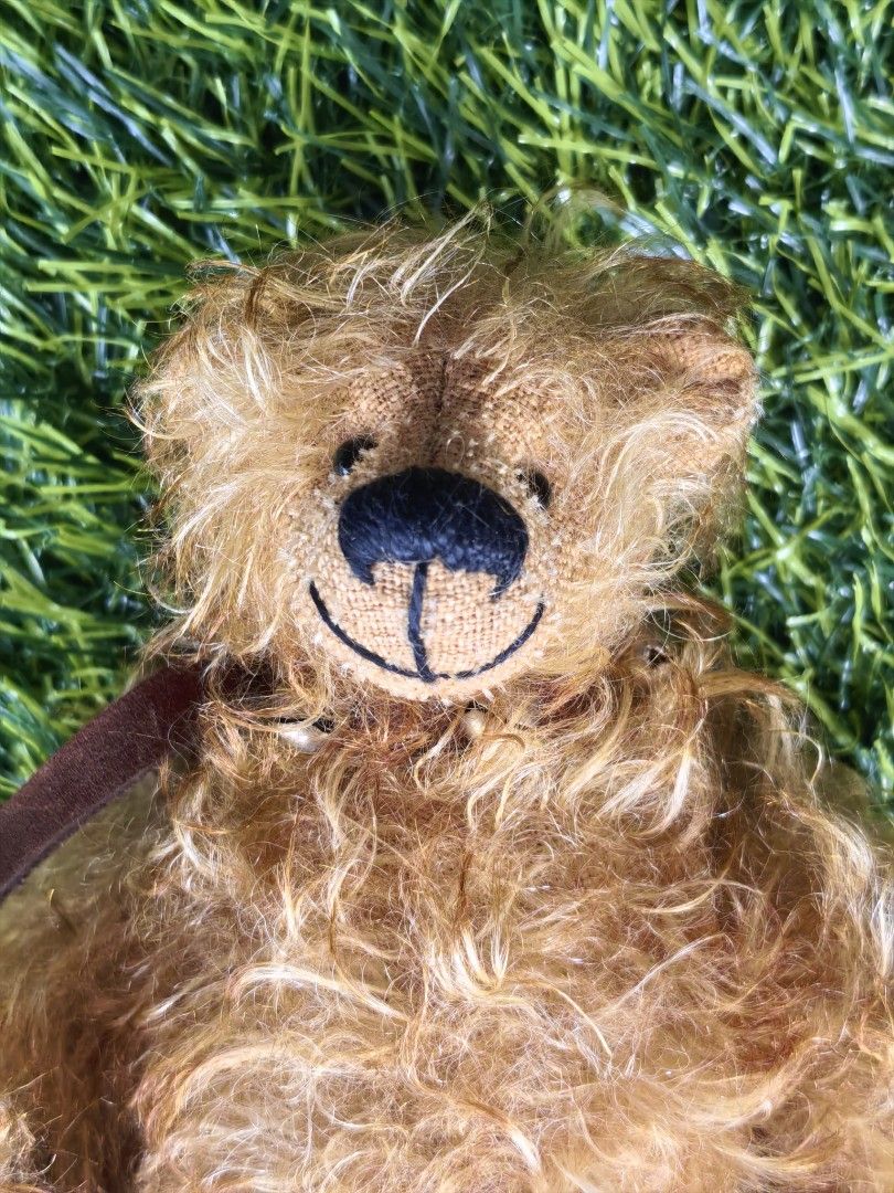 Fluffy Brown Teddy Bear with Leather-like Paws (Category: Plushies & Soft Toys) located in Paranaque City. Submitted by furugiyafinds (Listing ID 1465225817, Image 2). Description: Fuzzy golden brown teddy bear with shaggy fur. Dark brown faux leather paw pads with stitched details. Embroidered black nose and smiling mouth. Small brown ribbon around the neck. Soft stuffed body, fully jointed limbs. Clean fur, well-kept toy from a smoke-free home.