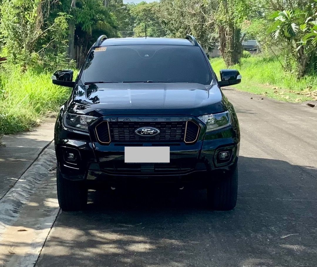 Ford Ranger (Category: Used Cars) located in Makati City. Submitted by sergeant1466934 (Listing ID 1465267914, Image 3). Description: Here are details of the car: Ford Ranger Wildtrak 4x4 AT Bi-Turbo 2022 model Registered end of August 2021 21,000 kms Fully maintained only by Ford, with invoices as proof 2 new front tyres New battery 2025 No accidents or accident repairs, all as original. Features: Factory fitted Ford electric roller shutter for 