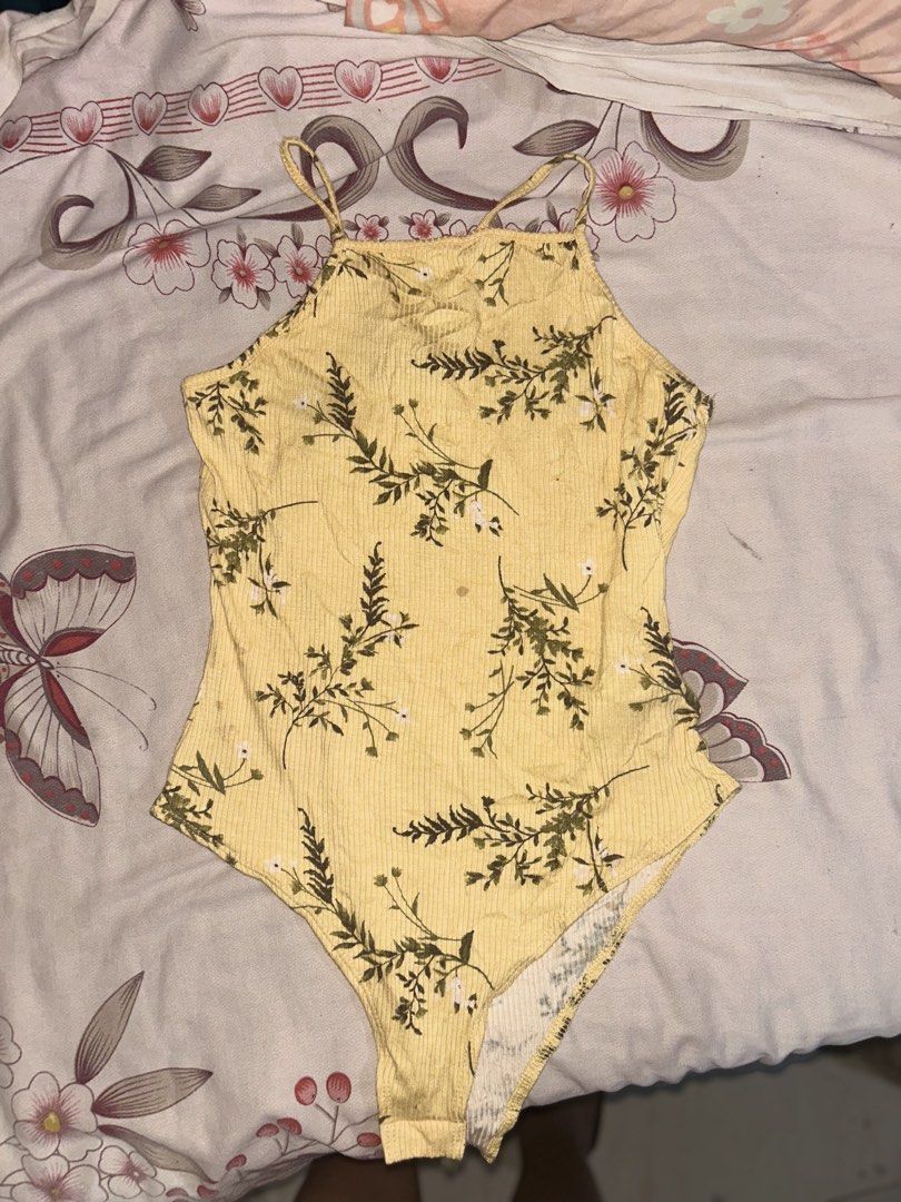 Forever 21 Ribbed Bodysuit (Category: Sleeveless) located in Mandaluyong City. Submitted by mariamadeline (Listing ID 1465341253, Image 1). Description: - Brand: Forever 21 - Size: Medium (fits true to size) - Design: Yellow ribbed fabric with all-over green floral print, high neck, and thin adjustable back straps.