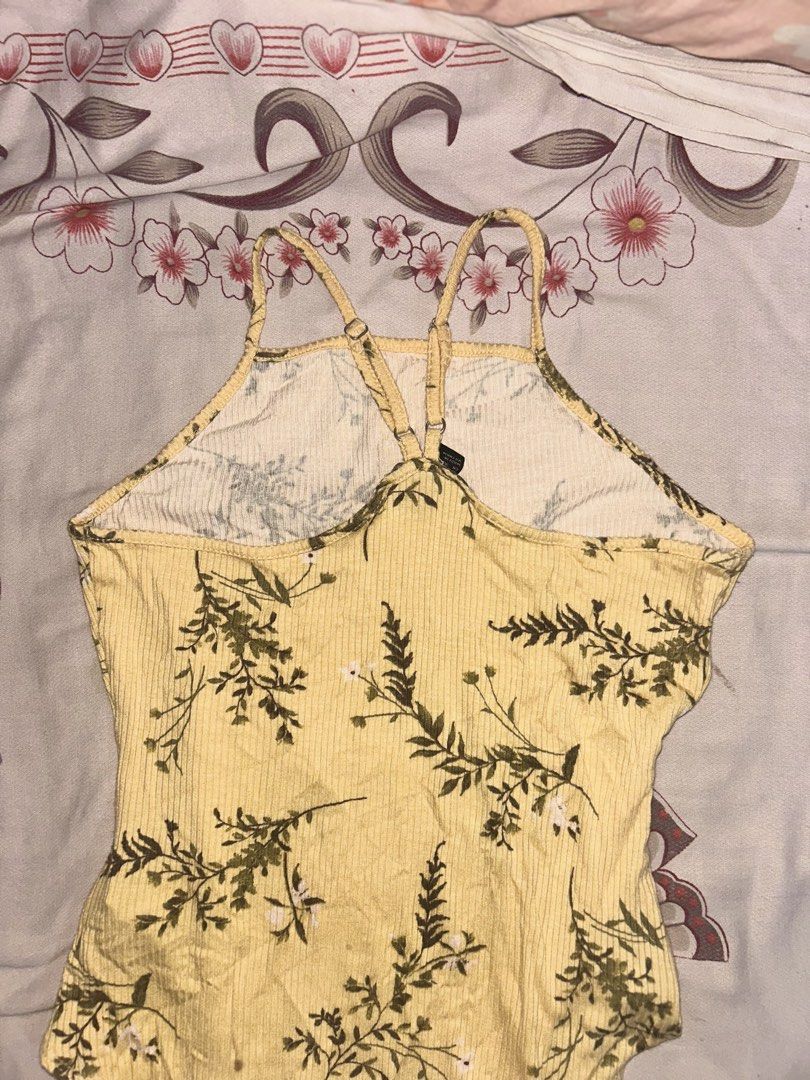 Forever 21 Ribbed Bodysuit (Category: Sleeveless) located in Mandaluyong City. Submitted by mariamadeline (Listing ID 1465341253, Image 2). Description: - Brand: Forever 21 - Size: Medium (fits true to size) - Design: Yellow ribbed fabric with all-over green floral print, high neck, and thin adjustable back straps.