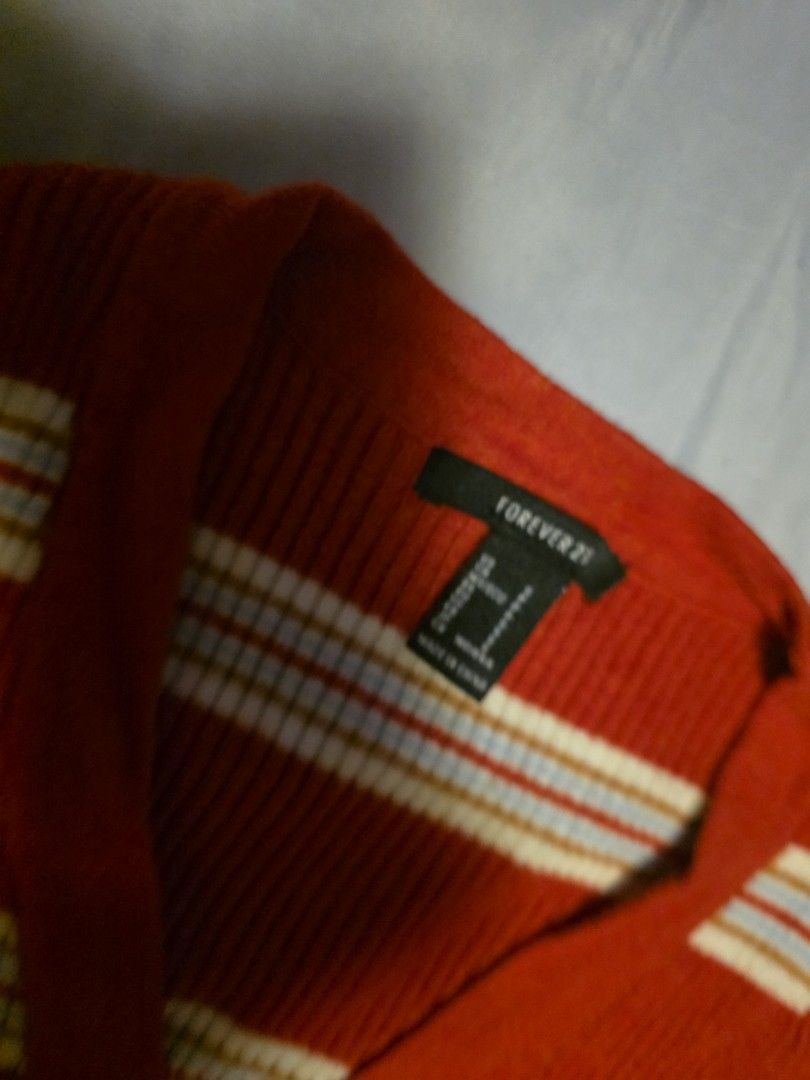Forever 21 Striped Long Sleeve Bodysuit (Category: Longsleeves) located in Manila. Submitted by cher0918 (Listing ID 1465269485, Image 2). Description: - Brand: Forever 21 - Style: Long-sleeve ribbed bodysuit with V-neckline and 3 front buttons - Color: Rust red with white and blue stripes - Fit: Snug, stretchy, and flattering - Closure: Convenient bottom snap closure - Condition: Excellent, tag intact.