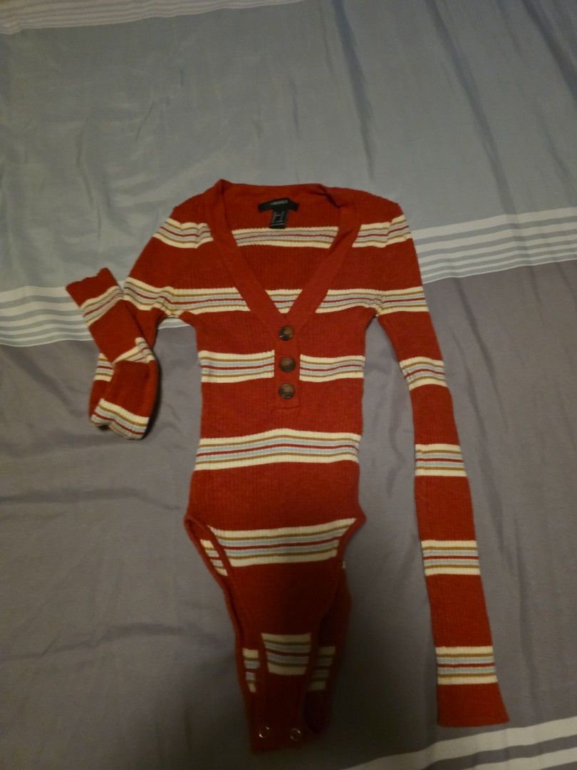 Forever 21 Striped Long Sleeve Bodysuit (Category: Longsleeves) located in Manila. Submitted by cher0918 (Listing ID 1465269485, Image 1). Description: - Brand: Forever 21 - Style: Long-sleeve ribbed bodysuit with V-neckline and 3 front buttons - Color: Rust red with white and blue stripes - Fit: Snug, stretchy, and flattering - Closure: Convenient bottom snap closure - Condition: Excellent, tag intact.