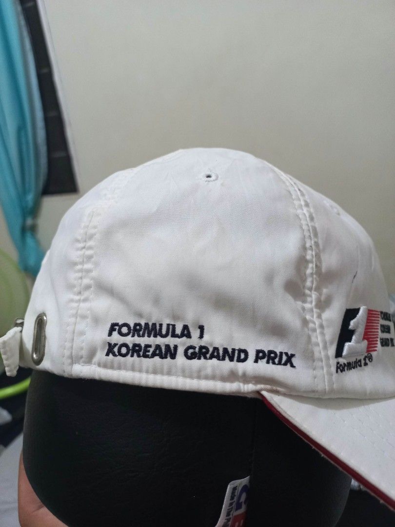 Formula 1 Korean Grand Prix White Cap (Category: Caps & Hats) located in Davao. Submitted by thegraildept2026 (Listing ID 1465178714, Image 3). Description: - Authentic White Formula 1 Korean Grand Prix cap - Embroidered F1 logos on the front and side - Stylish red stripe detail running down the back - Adjustable strap with a secure metallic buckle closure - Must-have piece for motorsport fans and collectors.