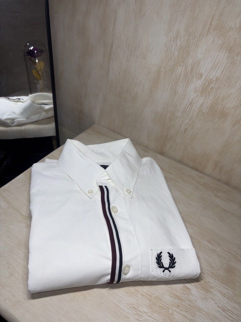 FRED PERRY TAPED PLACKET SHIRT (Category: Tshirts & Polo Shirts ) located in Cabuyao City. Submitted by pormanation-thrift-store (Listing ID 1465192883, Image 2). Description: FRED PERRY TAPED PLACKET SHIRT Condition: LIKE NEW Color rate: 10/10 (PWEDE SA MASELAN) Size: SMALL Dimes: 19”Wx28”L Issue: NONE❌ Price: 2000.
