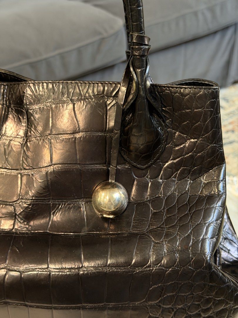 Furla Crocodile Embossed Leather Tote Bag (Category: Luxury Bags & Wallets) located in Santa Rosa. Submitted by ktd312 (Listing ID 1465211002, Image 2). Description: Bag and dust bag only - Brand: Furla (Made in Italy) - Material: Black crocodile-embossed leather - Hardware: Silver-tone with hanging ball charm - Closure: Secure magnetic snap - Interior: Black Furla logo fabric lining with 1 zipped pocket - Handles: Dual top handles for comfortabl