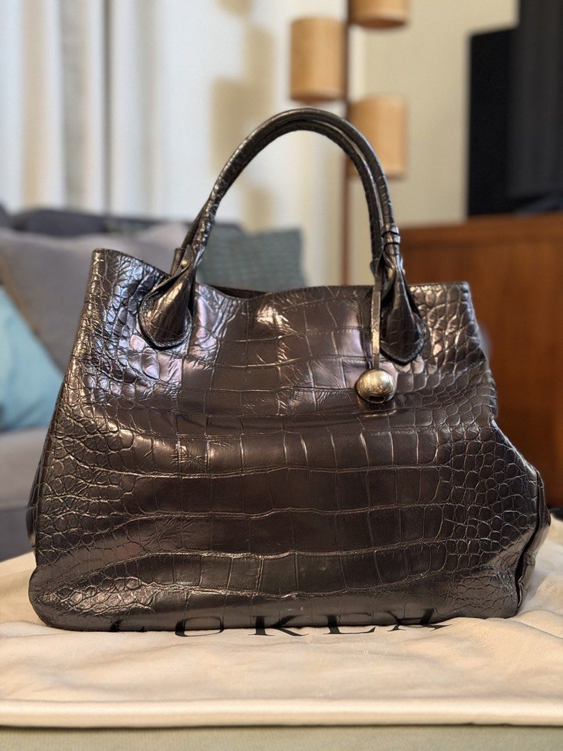 Furla Crocodile Embossed Leather Tote Bag (Category: Luxury Bags & Wallets) located in Santa Rosa. Submitted by ktd312 (Listing ID 1465211002, Image 1). Description: Bag and dust bag only - Brand: Furla (Made in Italy) - Material: Black crocodile-embossed leather - Hardware: Silver-tone with hanging ball charm - Closure: Secure magnetic snap - Interior: Black Furla logo fabric lining with 1 zipped pocket - Handles: Dual top handles for comfortabl