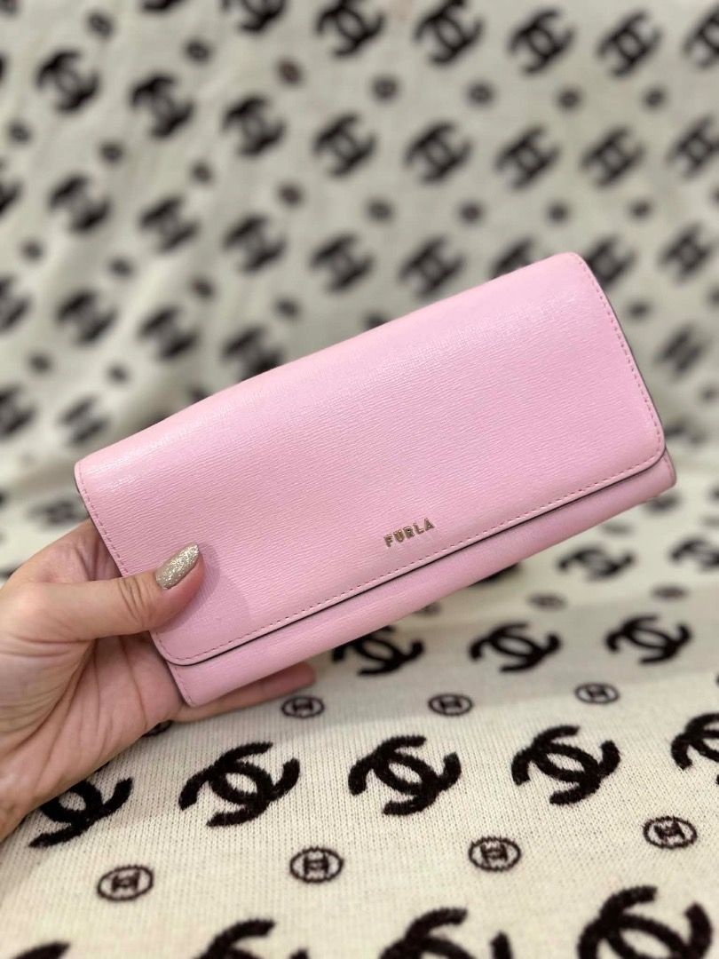 Furla Pink Leather Long Wallet (Category: Wallets & Card holders) located in San Pedro. Submitted by silverlion-4d46 (Listing ID 1465214036, Image 1). Description: - Brand: Furla - Color: Pink with chic gold-tone hardware - Closure: Flap with secure snap button - Interior: Multiple card slots, spacious compartments, and a convenient zippered coin pocket - Condition: Clean leather exterior and interior lining, minimal wear, very well-kept.