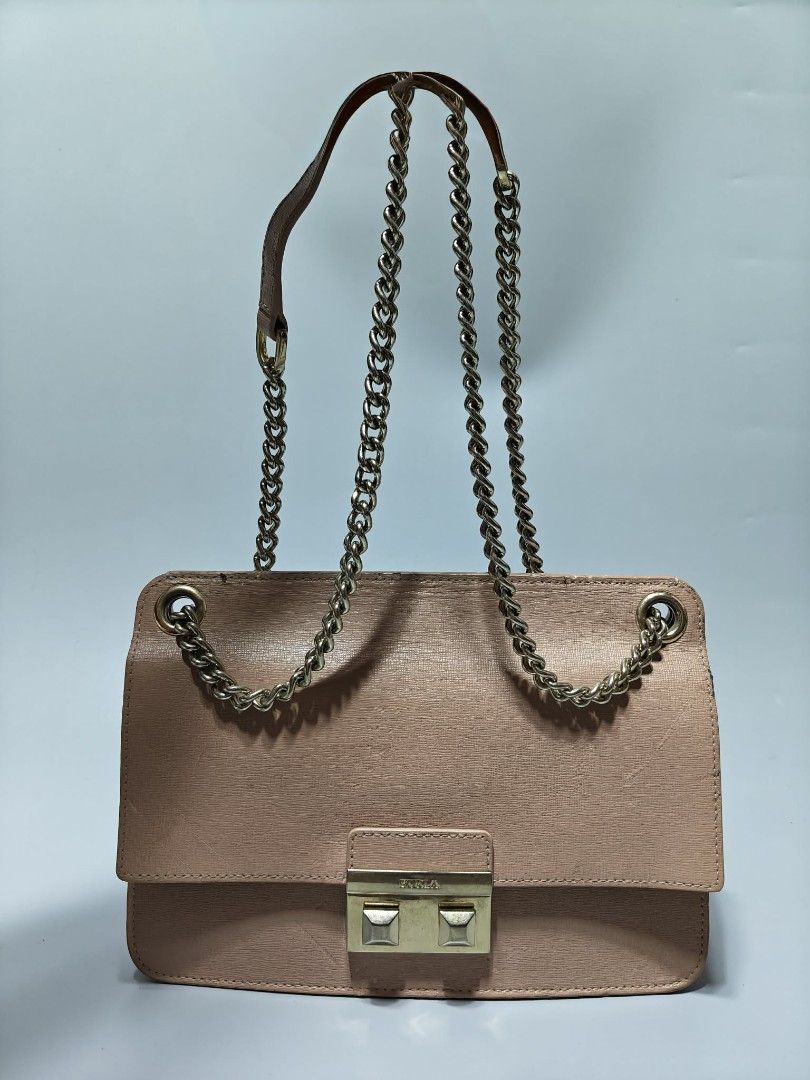 Furla Pink Leather Shoulder Bag with Chain Strap (Category: Luxury Bags & Wallets) located in Manila. Submitted by 9baguio_base. (Listing ID 1465178092, Image 1). Description: - Authentic Furla shoulder bag in pink textured leather - Elegant gold-tone chain strap with comfortable leather shoulder guard - Secure front flap closure with metallic Furla logo lock plate - Structured rectangular shape with spacious interior for daily essentials - Condi
