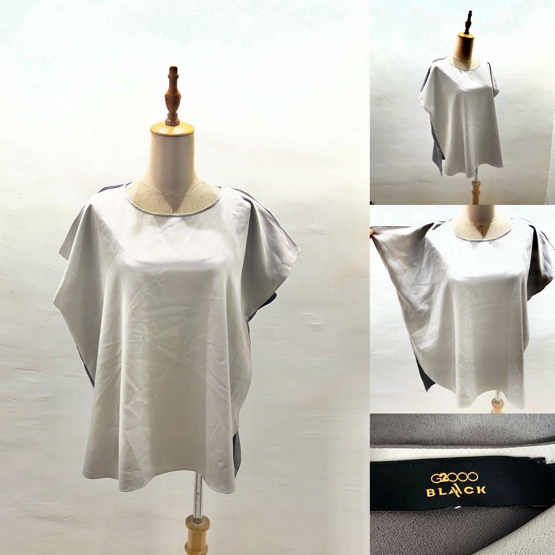 G2000 Black Grey Cap Sleeve Blouse (Category: Blouses) located in Bacolod City. Submitted by bhabissagal-05763 (Listing ID 1465202330, Image 1). Description: - Brand: G2000 Black Label - Color: Light grey front with darker grey back and sides - Fit: Loose, boxy fit with wide short sleeves and scoop neckline - Material: Smooth, lightweight fabric with neat collar stitching - Condition: Clean inside label, excellent pre-loved condition - Styling: P