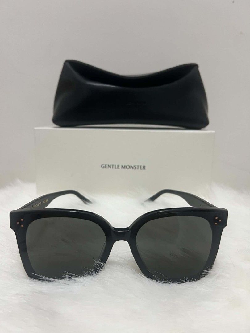 Gentle Monster Shades with Case & Box (Category: Sunglasses & Eyewear) located in Paoay. Submitted by rvf1230 (Listing ID 1465187518, Image 3). Description: - Brand: Gentle Monster - Model: Her - Color: Classic black with dark tinted lenses - Frame: Oversized square - Condition: Clean, well-stored - Inclusions: Original white storage box, black leather case, and branded paper bag.
