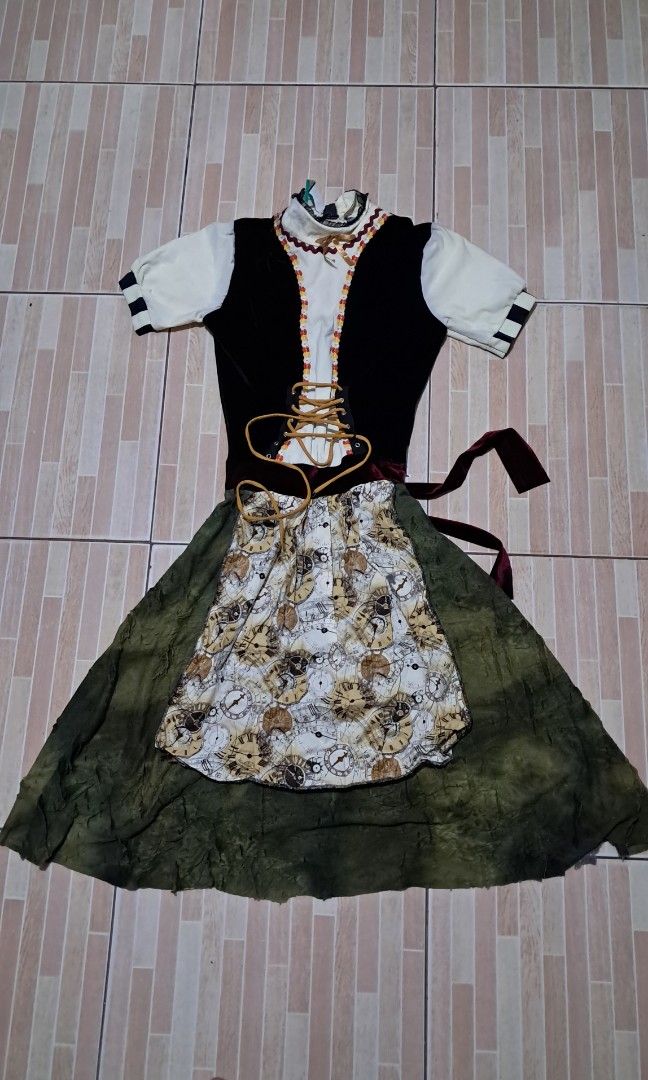 German dirndl dress small-medium (Category: Babies & Kids Fashion) located in Las Pinas. Submitted by kaswakto (Listing ID 1465206856, Image 1). Description: 〽️ Traditional-style German dirndl dress featuring a black velvet-look vest bodice, a white puff-sleeve blouse, an olive-green skirt, and an apron printed with vintage clock graphics. size small-medium 〽️ Dimensions: 39 inches length x 13.5 inches width/ 11 inches waistline 〽️ excellent cond