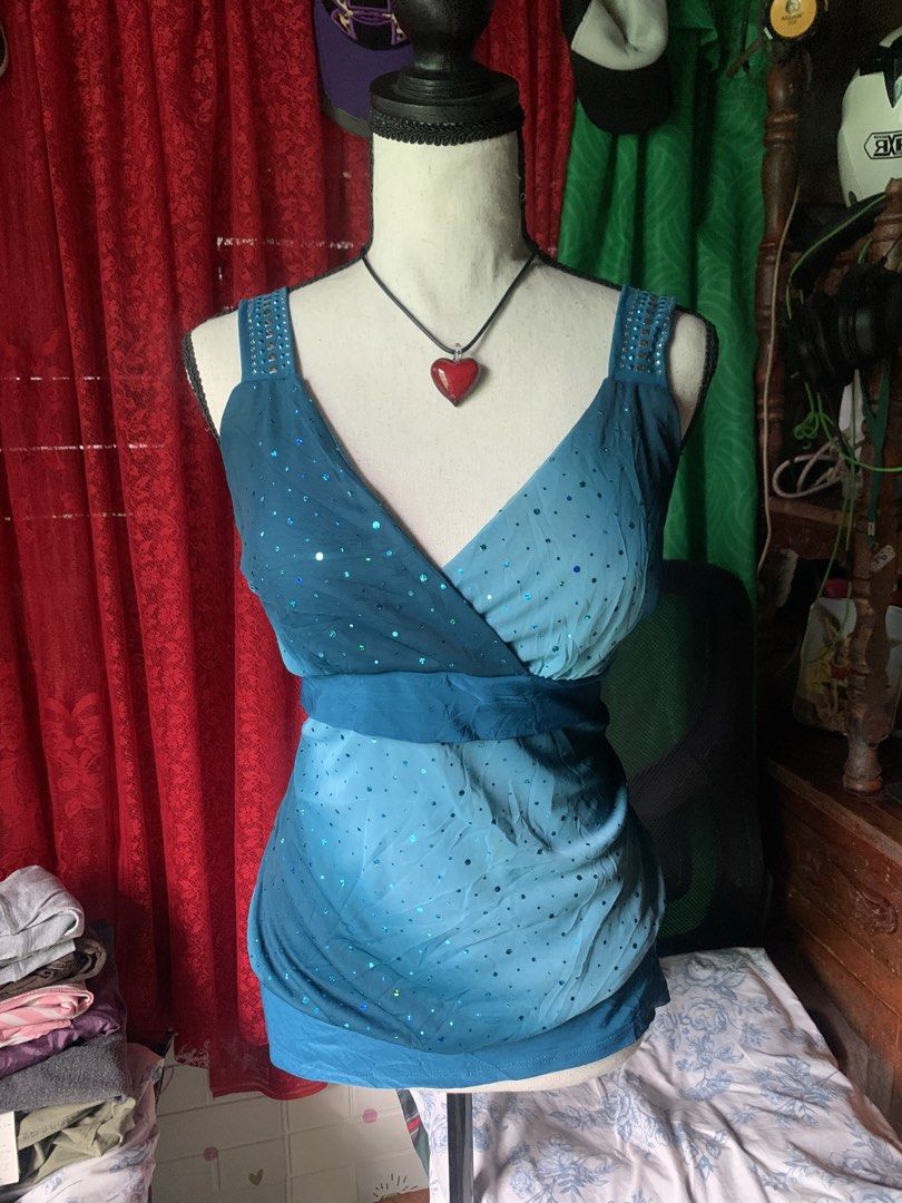 Gidani U.S.A. Blue Ombre Sequins Blouse (Category: Blouses) located in Cebu City. Submitted by selamethrift (Listing ID 1465263361, Image 1). Description: - Brand/Origin: Gidani U.S.A. (Made in USA) - Color/Design: Teal and light blue ombre sleeveless blouse - Size: XL / Xgrande can fit med-large - Neckline & Straps: Wrap style V-neck with sparkling sequin details and wide straps featuring studded metal embellishments - Fit & Style: Flowy fabric 