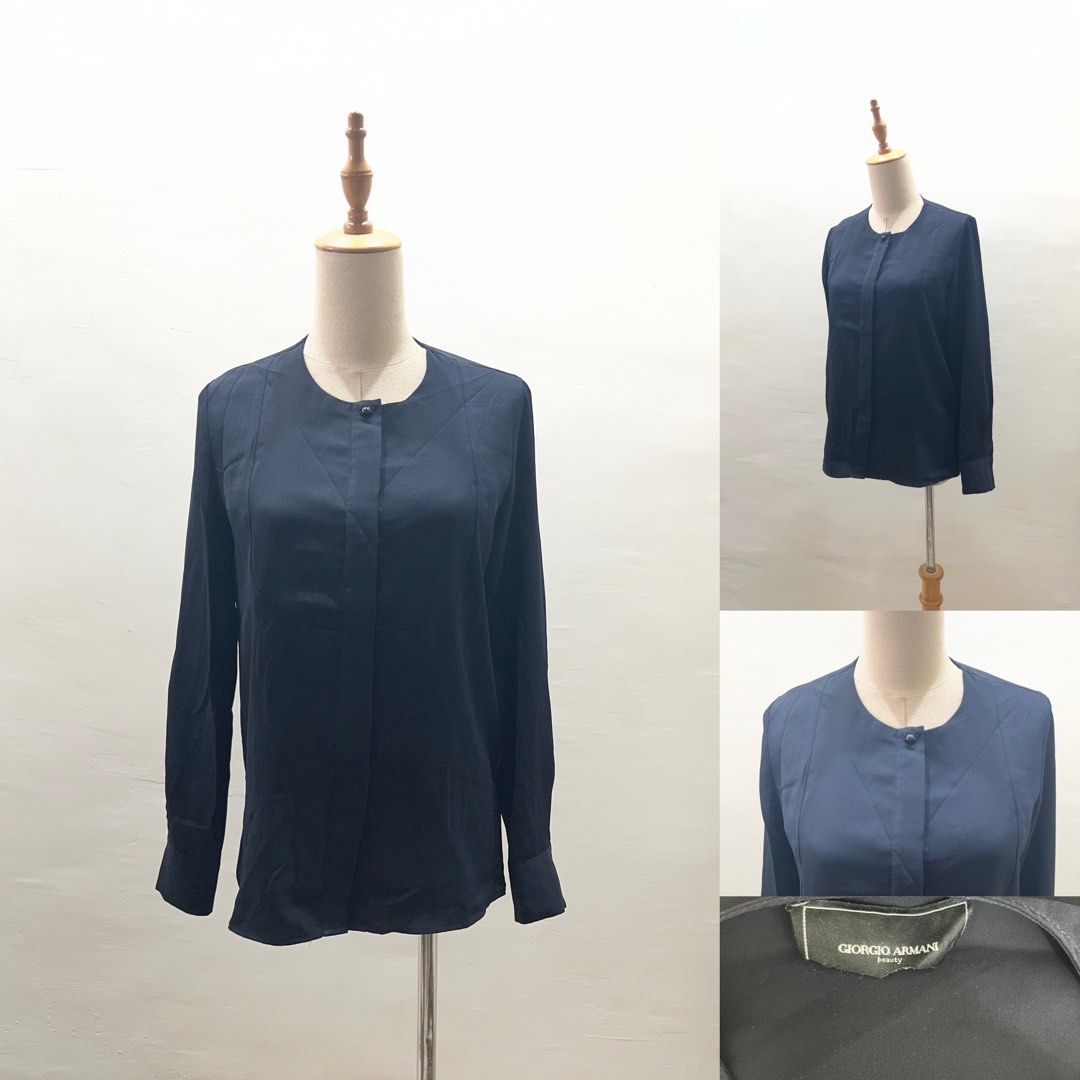 Giorgio Armani Navy Blue Long Sleeve Blouse (Category: Longsleeves) located in Bacolod City. Submitted by bhabissagal-05763 (Listing ID 1465202095, Image 1). Description: - Brand: Giorgio Armani - Color: Classic navy blue - Style: Long-sleeve button-down blouse with structured front paneling - Neckline: Clean round neckline with concealed button placket - Cuffs: Tailored fit with button closures - Material: Smooth, premium fabric texture - Condit