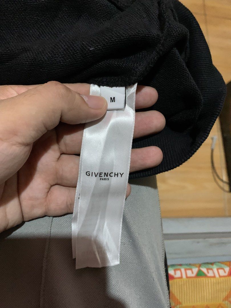 Givenchy Cat Graphic Black Sweatshirt Size M (Category: Coats, Jackets and Outerwear) located in Davao. Submitted by sadthrift (Listing ID 1465183353, Image 3). Description: - Brand: Givenchy - Color: Black - Size: M (Oversized fit) - Material: 100% Cotton, Made in Portugal - Design: Bold cat face graphic print with logo branding accents - Details: Ribbed cuffs, collar, and hem; long sleeves - Condition: Brand tags and wash care label intact.