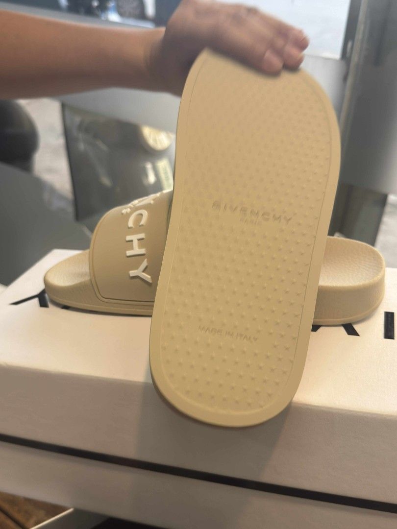 Givenchy Paris Beige Rubber Slides (Category: Slippers and slides) located in San Mateo. Submitted by meymei91 (Listing ID 1465218685, Image 1). Description: - Brand: Givenchy Paris - Color: Beige with white raised logo lettering - Style: Slip-on rubber slides with molded footbed - Details: Textured outsole, "Made in Italy" stamping - Condition: Clean, no scuffs - Inclusions: Original white box.