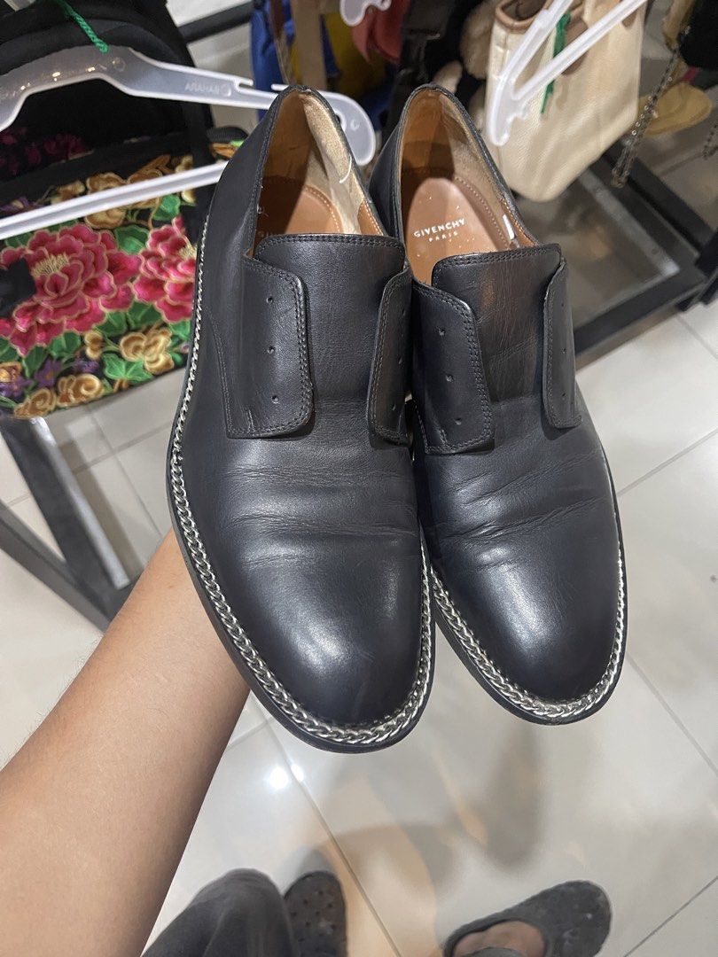 Givenchy Paris Black Leather Chain Trim Loafers (Category: Loafers) located in Cavite. Submitted by thriftkicks3 (Listing ID 1465282630, Image 3). Description: - Brand: Givenchy Paris - Color: Black with natural tan leather interior lining - Style: Edgy designer slip-on flats with distinctive chain detail along the welt and heel - Condition: Good pre-loved condition with normal creasing on top and minor scuffs at the heels - Perfect for adding a 