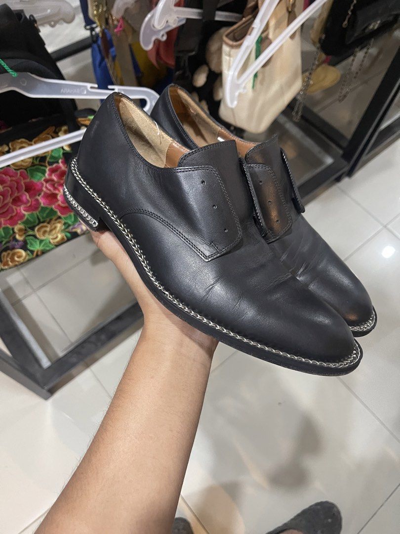 Givenchy Paris Black Leather Chain Trim Loafers (Category: Loafers) located in Cavite. Submitted by thriftkicks3 (Listing ID 1465282630, Image 2). Description: - Brand: Givenchy Paris - Color: Black with natural tan leather interior lining - Style: Edgy designer slip-on flats with distinctive chain detail along the welt and heel - Condition: Good pre-loved condition with normal creasing on top and minor scuffs at the heels - Perfect for adding a 