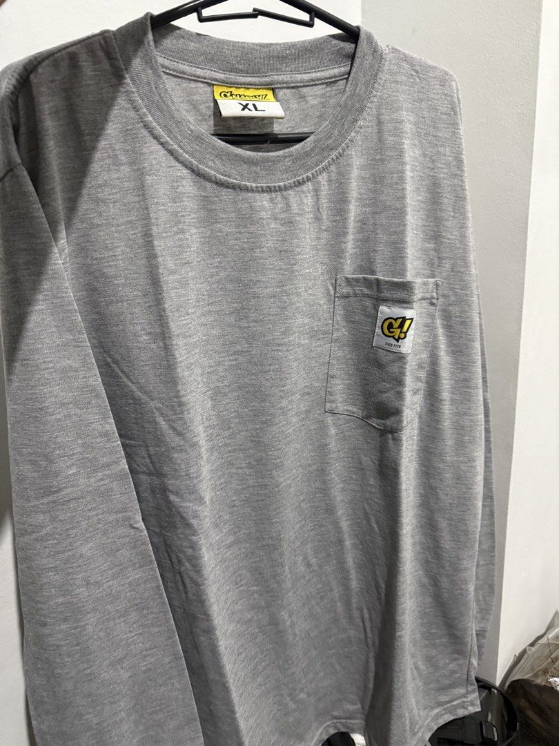 Gnarly Long Sleeve (Category: Tshirts & Polo Shirts ) located in Mandaluyong City. Submitted by whitemoveout (Listing ID 1465325794, Image 1). Description: - Brand: Gnarly! - Size: XL - Color: Heather grey - Material: Cotton blend - Design: Long sleeve with standard crew neckline - Details: Chest pocket with 'G!' logo patch and small yellow/black hem tag - Condition: Excellent / Well-maintained.