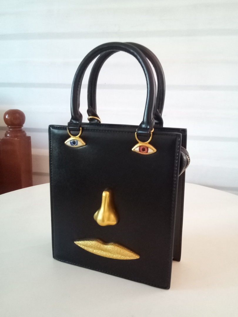 Gold and black Face bag Schiaparelli (Category: Tote Bags) located in Makati City. Submitted by pinkeealvarez (Listing ID 1465201505, Image 1). Description: length 20cm width 8cm height 23cm.