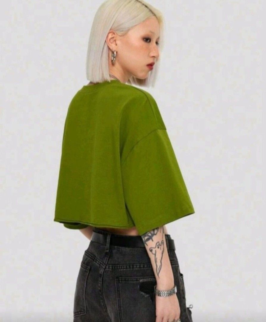 Green crop top (Category: Shirts) located in Manila. Submitted by red_06 (Listing ID 1465245209, Image 3). Description: - Green crop top - Features a bold 'DUMP HIM' graphic - Short, wide sleeves - Raw hem design - Vibrant green color - Stylish and trendy - Perfect for casual outfits - Made of comfortable material.