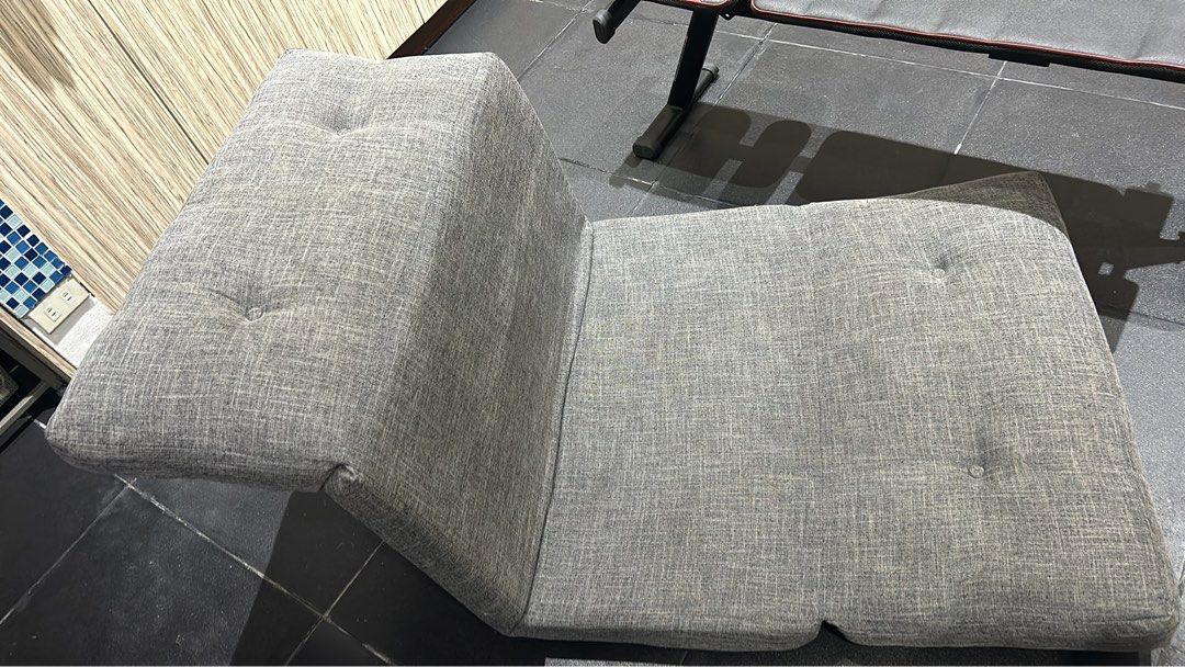 Grey Convertible Floor Sofa Bed Adjustable Lounge Chair (Category: Sofas) located in Pasig City. Submitted by sevyenti (Listing ID 1465170861, Image 3). Description: - Versatile design: Functions as an upright chair or folds flat into a single mattress - Stylish & comfortable: Textured grey woven upholstery with elegant button tufting details - Space-saving: Perfect for small apartments, living rooms, or bedrooms - Easy to adjust: Smoothly switch