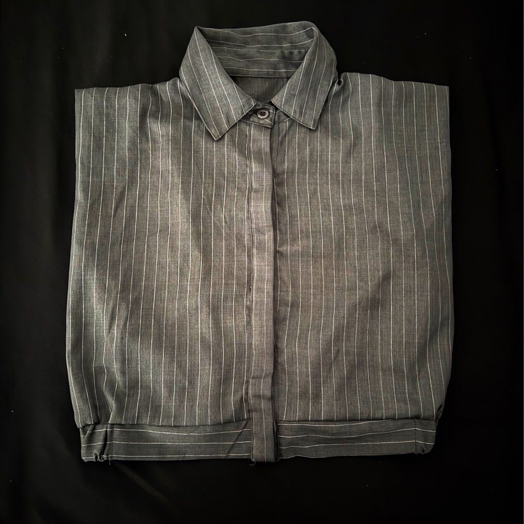 Grey striped short sleeve button-down shirt (Category: Shirts) located in Manila. Submitted by jhoysfabcloset (Listing ID 1465236177, Image 1). Description: - Color & Pattern: Dark grey with thin vertical stripes - Design: Short sleeve, classic collar, and standard button placket - Material: Lightweight fabric with a smooth, crisp finish - Condition: Excellent, no stains, tears, or loose threads.