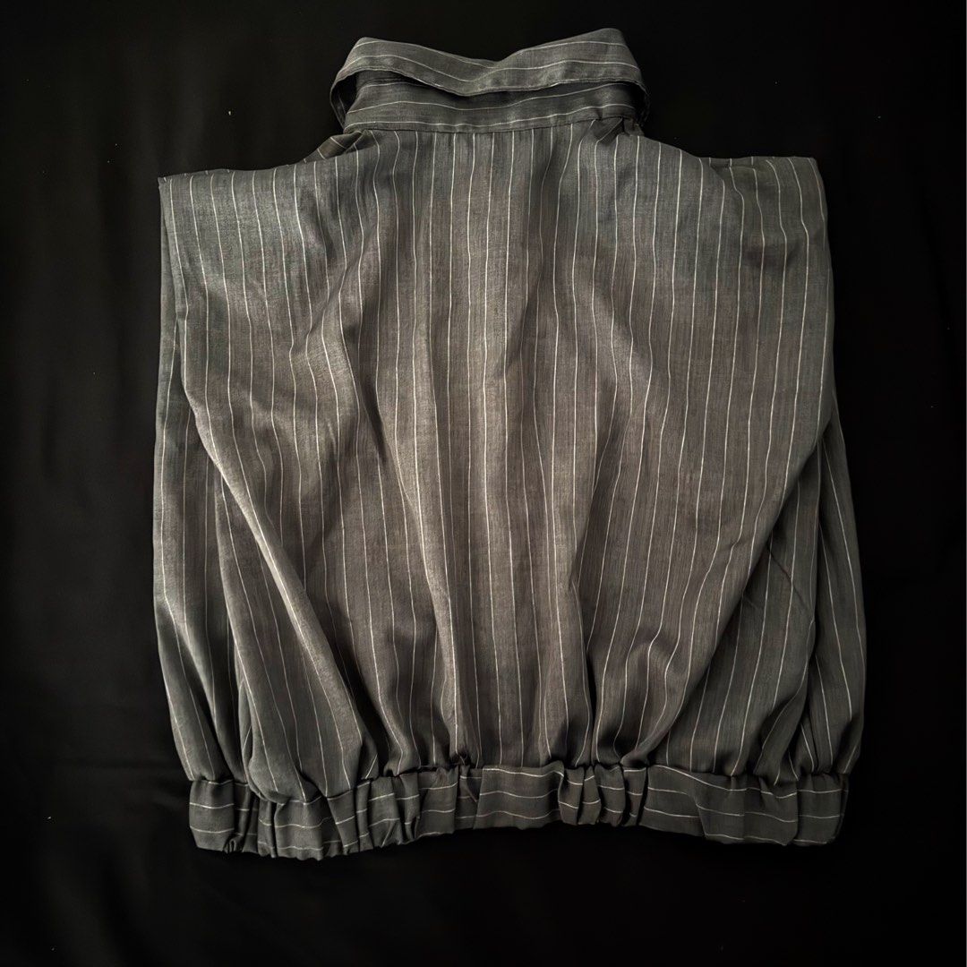 Grey striped short sleeve button-down shirt (Category: Shirts) located in Manila. Submitted by jhoysfabcloset (Listing ID 1465236177, Image 2). Description: - Color & Pattern: Dark grey with thin vertical stripes - Design: Short sleeve, classic collar, and standard button placket - Material: Lightweight fabric with a smooth, crisp finish - Condition: Excellent, no stains, tears, or loose threads.