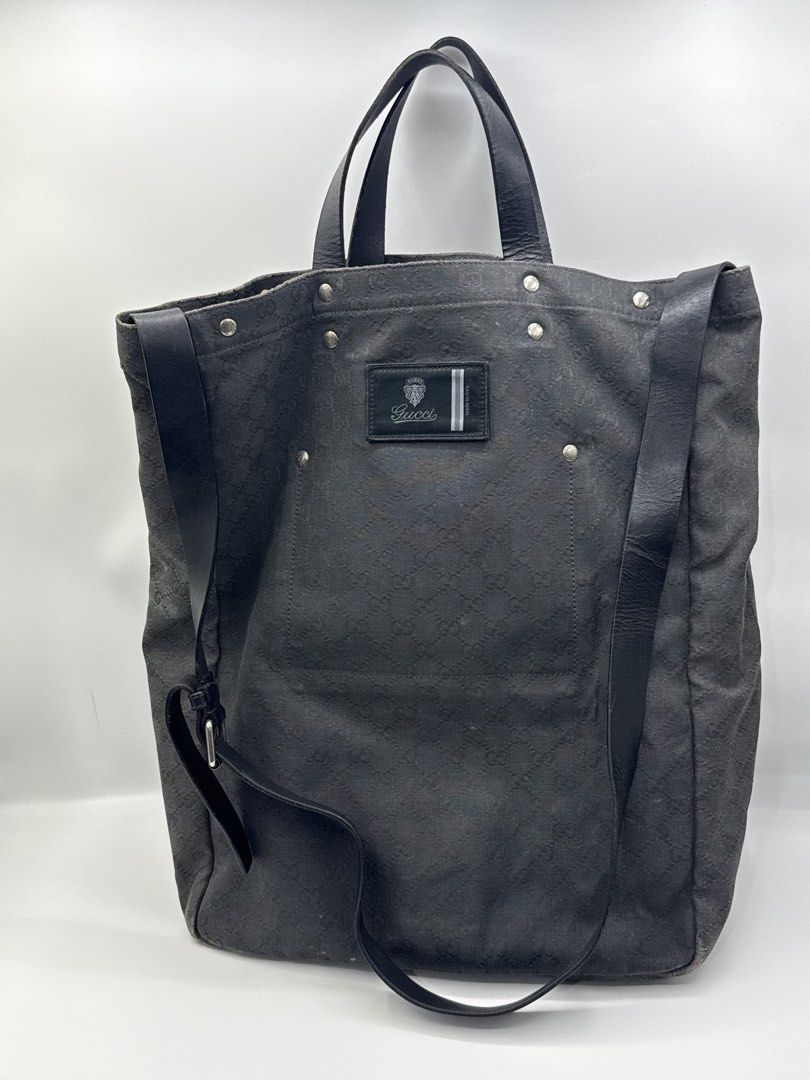 Gucci bag (Category: Sling Bags) located in Caloocan City. Submitted by rossvault2 (Listing ID 1465231710, Image 1). Description: Gucci tote bag in dark grey or black canvas with the classic interlocking G monogram pattern. Black leather handles and an adjustable shoulder strap. Large front slip pocket and zipped rear pocket, both with branded hardware. Gucci logo patch sewn onto the front center. -authentic -needs cleaning/bagspa -normal signs o
