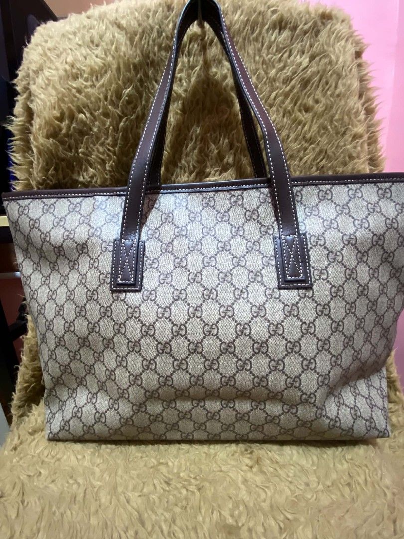 Gucci GG Monogram Tote Bag Brown Leather (Category: Luxury Bags & Wallets) located in Manila. Submitted by goodbuying_items0211 (Listing ID 1465273722, Image 2). Description: - Gucci tote in classic GG monogram canvas - Elegant brown leather trim with white contrast stitching - Secure top zip closure with gold-tone hardware - Comfortable double top handles for easy shoulder wear - Clean exterior and spacious dark fabric-lined interior with a slip