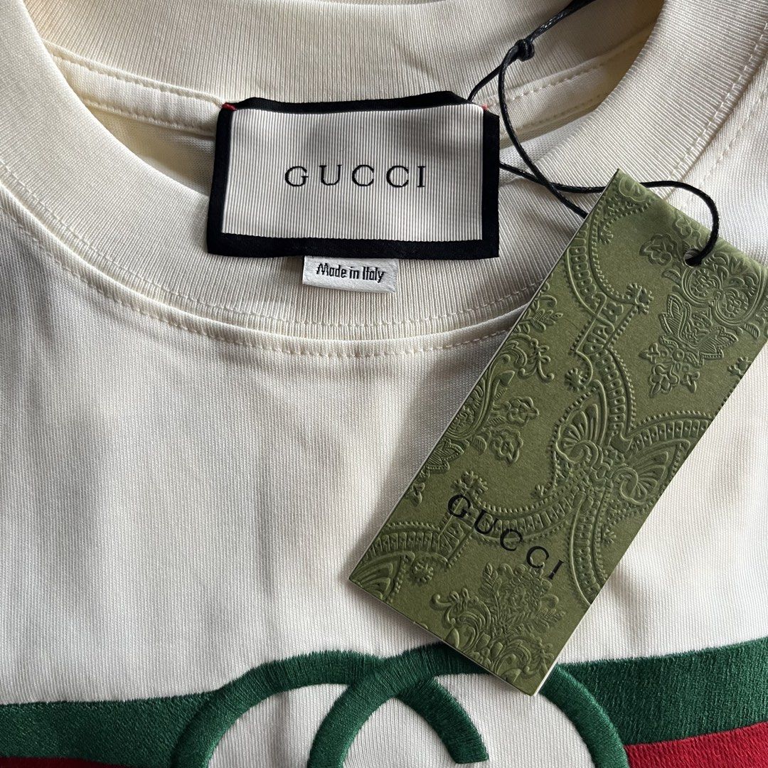 Gucci White Interlocking G Logo T-Shirt (Category: Activewear) located in Davao. Submitted by gotchastuff (Listing ID 1465268388, Image 3). Description: - 100% Authentic Gucci Short Sleeve Tee - Color: Off-white - Size: Small - Dimes 22x29 - Material: Premium cotton, Made in Italy - Design: Classic green/red web stripe, embroidered interlocking G logo, and bold Gucci lettering - Condition: Brand new with original paper hang tag attached - Guarant
