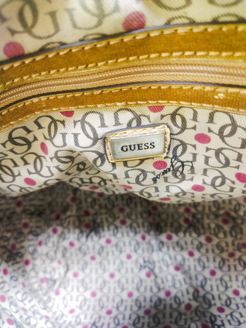 Guess Cream Monogram Quilted Handbag (Category: Shoulder Bags) located in Manila. Submitted by dei03_diz (Listing ID 1465212051, Image 3). Description: - Brand: Guess (Made in Indonesia) - Color/Pattern: Cream with iconic monogram pattern and quilted texture - Straps: Brown shoulder straps with stylish white accent tabs - Hardware: Elegant gold-tone GUESS front plaque - Closure: Secure zip top closure - Interior: Monogram fabric lining with playf