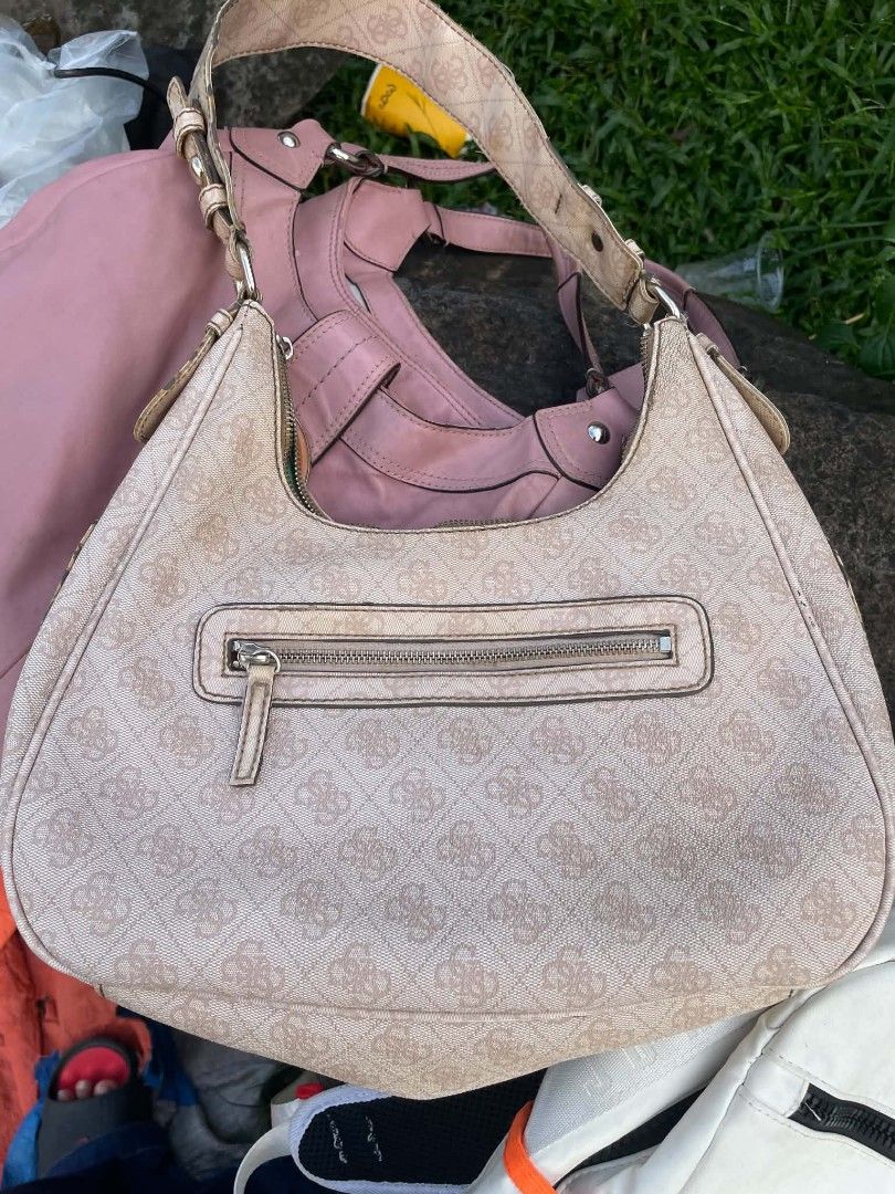 Guess Monogram Shoulder Bag with Buckle Detail (Category: Shoulder Bags) located in Cainta. Submitted by riszizlux (Listing ID 1465269892, Image 3). Description: - Brand: Guess - Color/Design: Pink monogram print with silver-tone hardware - Exterior: Two buckle accents on the front, metal logo plate, and a back zip pocket - Closure: Secure top zipper closure - Strap: Matching monogram shoulder strap with an adjustable buckle - Interior: Roomy spa