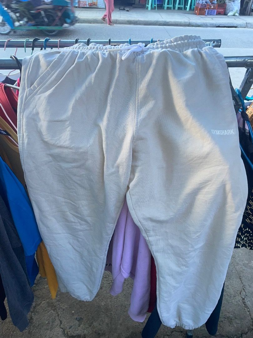 Gymshark Beige Sweatpants Size L (Category: Joggers) located in Puerto Princesa. Submitted by bestthrift123 (Listing ID 1465256029, Image 1). Description: - Brand: Gymshark - Color: Beige - Size: Large - Material: Soft fabric (Made in Bangladesh) - Design: Elastic waistband with white drawstring, white Gymshark logo on left thigh, and cuffed ankles - Fit/Usage: Comfortable fit, ideal for workouts or lounging.